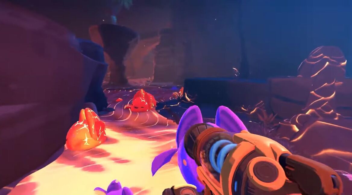 Die Protagonistin läuft durch eine Höhle voller Slimes in Slime Rancher 2