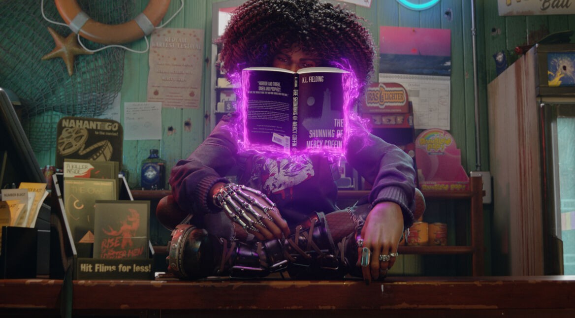 Layla sitzt im Schneidersitz auf einem Tresen und nutzt Telekinese, um ein Buch vor sich schweben zu lassen im Spiel Redfall Kritik