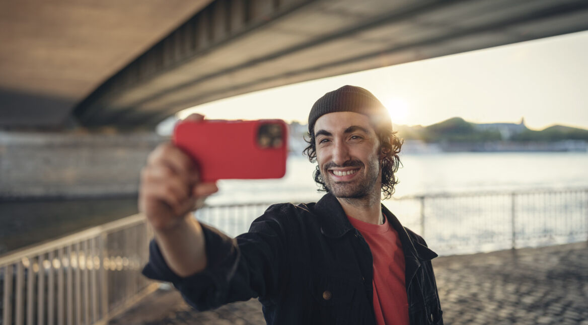 Mann hält Smartphone für ein Selfie