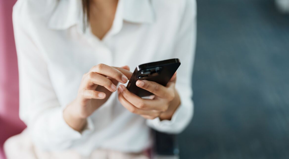 Frau öffnet Apple Wallet auf dem iPhone