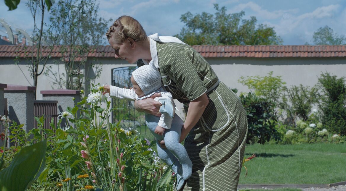 Eine Frau mit Baby im Garten
