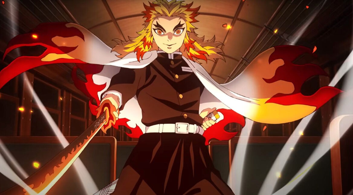 In diesem Bild aus dem Demon Slayer-Film „Mugen Train“ steht der Charakter Kyojuro Rengoku mit entschlossener Haltung in einem Zugabteil. Er trägt eine schwarze Uniform mit weißem Gürtel und einen auffälligen Umhang mit flammenförmigem Muster. Sein Schwert ist gezogen und leuchtet in feurigen Farben. Die Szene ist dynamisch und heroisch inszeniert.