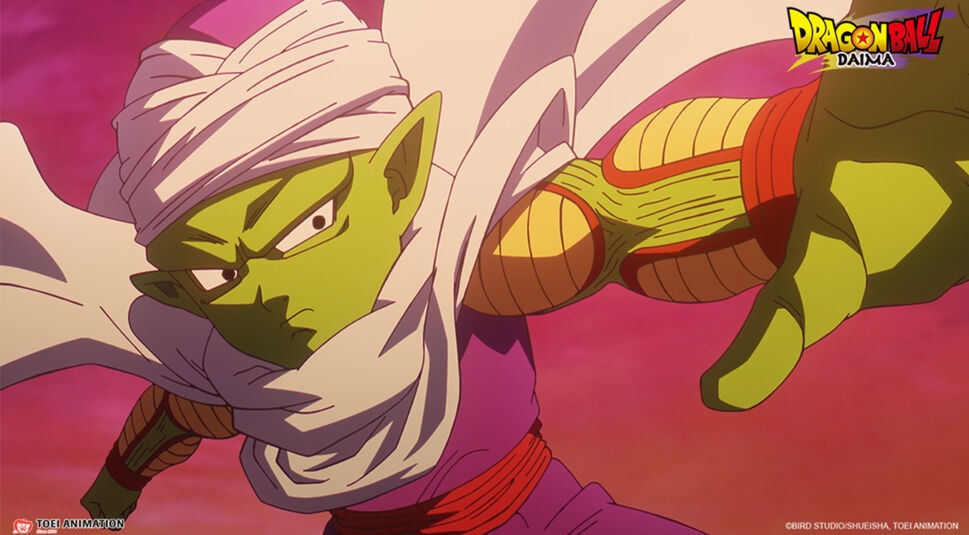 Auf dem Bild in dem Dragon Ball Daima-Artikel siehst Du Piccolo, der mit ernster Miene in einer Kampfpose steht. Seine grüne Haut und das weiße Turban-ähnliche Tuch sind deutlich zu erkennen, während er einen konzentrierten Blick nach vorn wirft.
