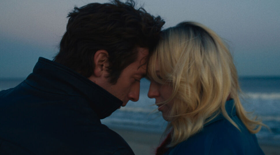 In dieser Szene aus Springsteen: Deliver Me From Nowhere stehen sich Jeremy Allen White als Bruce Springsteen und Odessa Young als Faye an einem ruhigen Strand gegenüber. Beide neigen ihre Stirn aneinander, die Augen geschlossen.