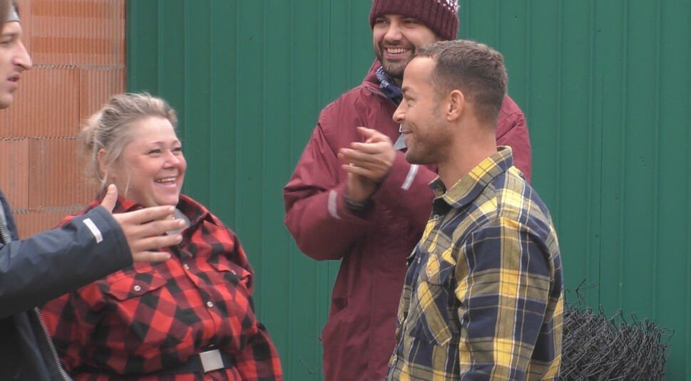 Auf dem Bild aus „Promi Big Brother“ 2025 stehen mehrere Bewohner:innen lachend und klatschend im Außenbereich des Hauses.