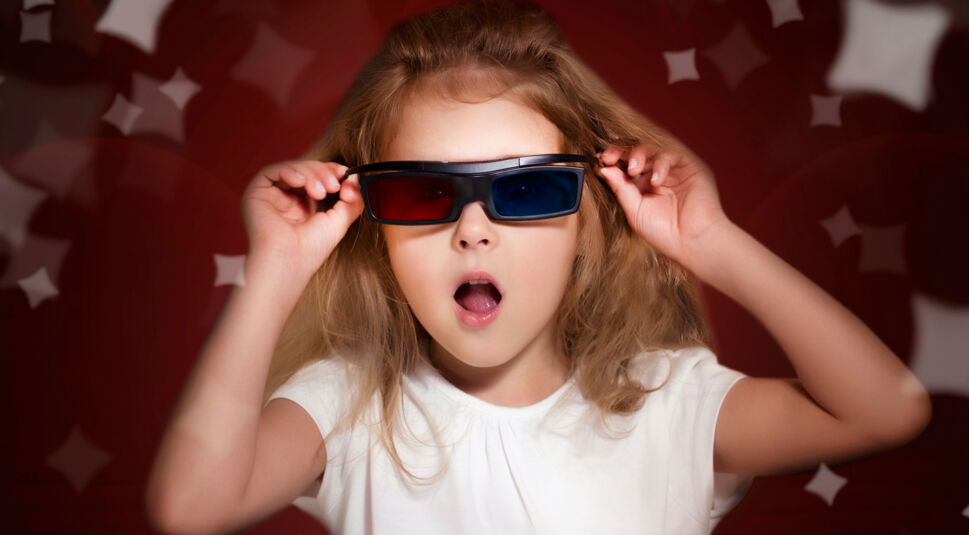 Child girl in 3d glasses watching movie.Kid in cinema.