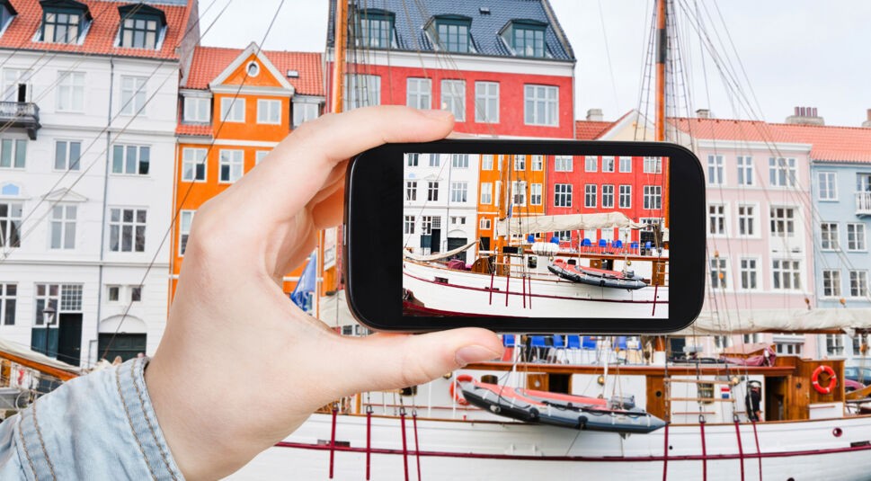tourist taking photo of Nyhavn waterfront