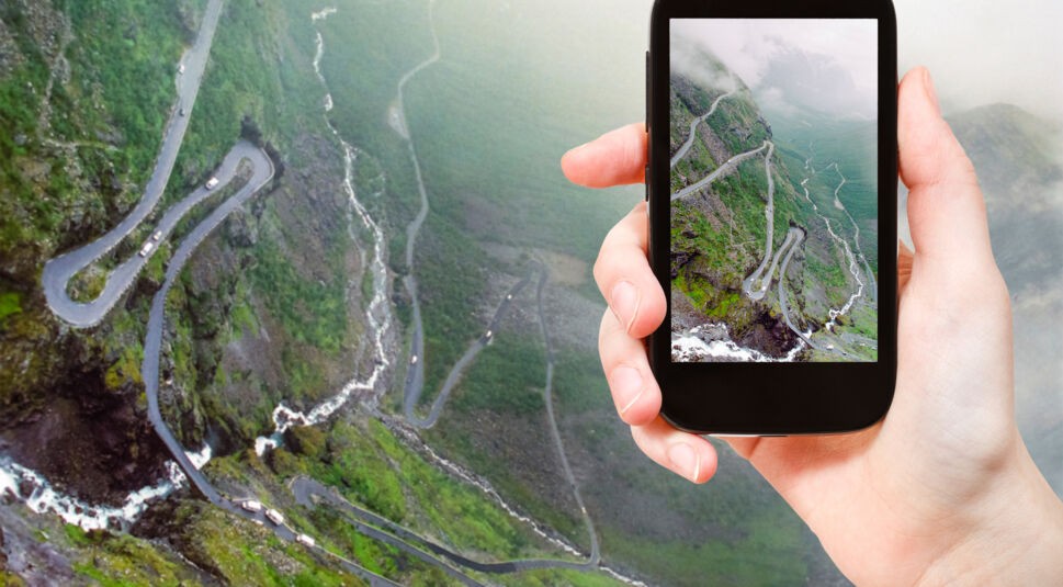 tourist taking photo of Trollstigen