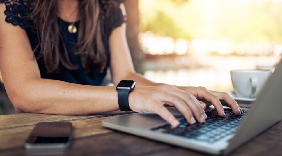 Woman working on laptop in a cafe