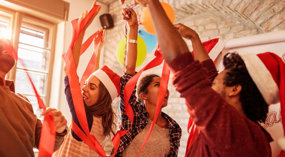 Cheerful business team dancing on a New Year's office party.
