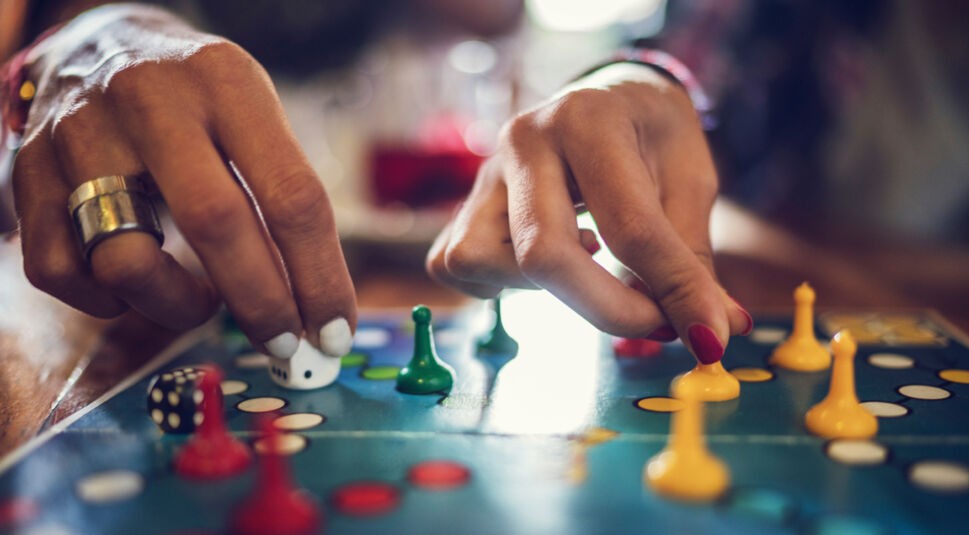 Close up of people playing cross and circle game.