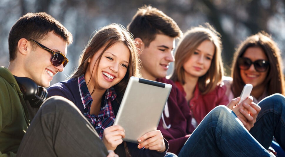 Young and happy urban people having fun with digital tablet