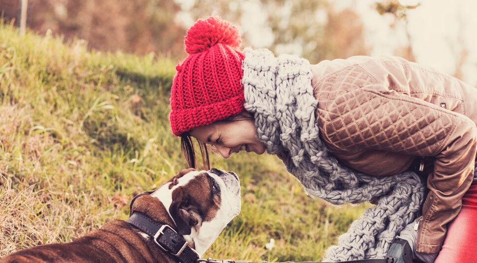 Women hugging a dog and kiss