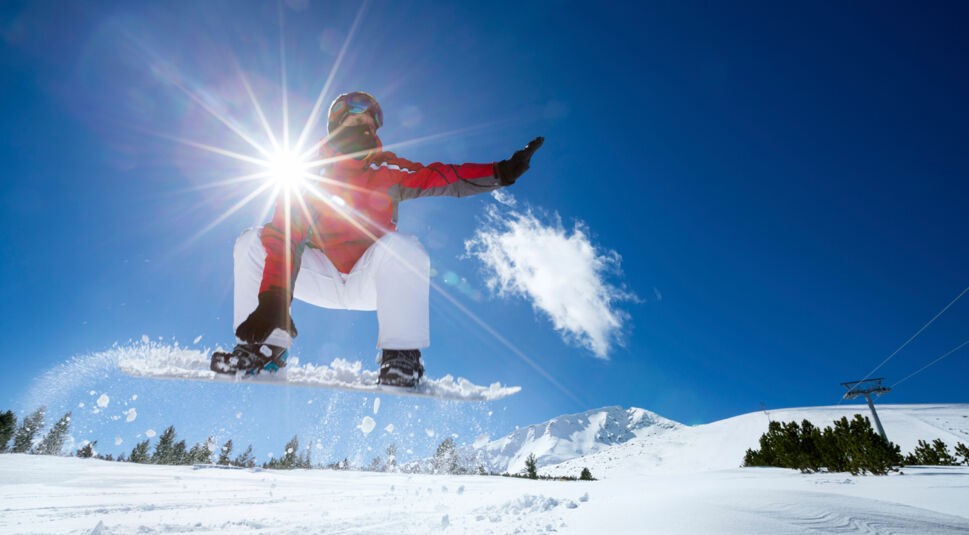 Snowboarder jumping in air