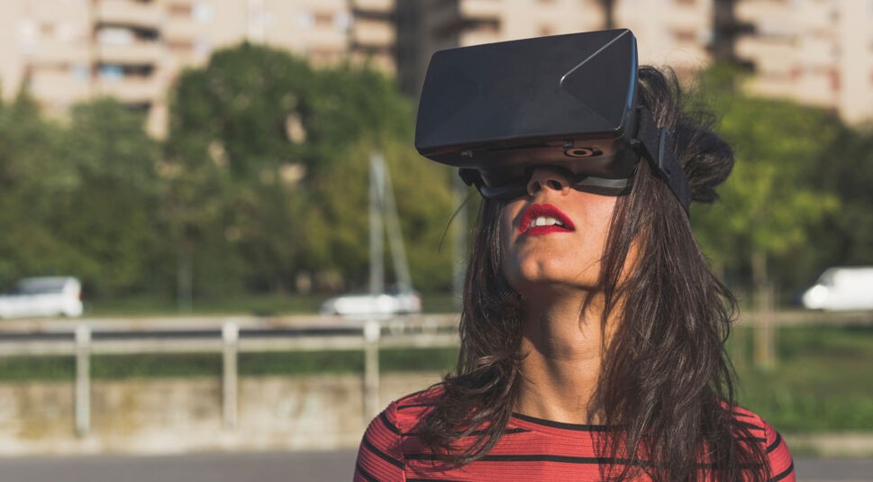 Beautiful young woman wearing virtual reality headset