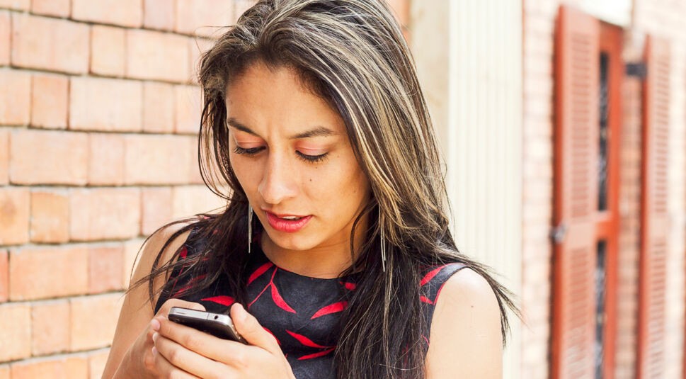 Woman walking with cellphone