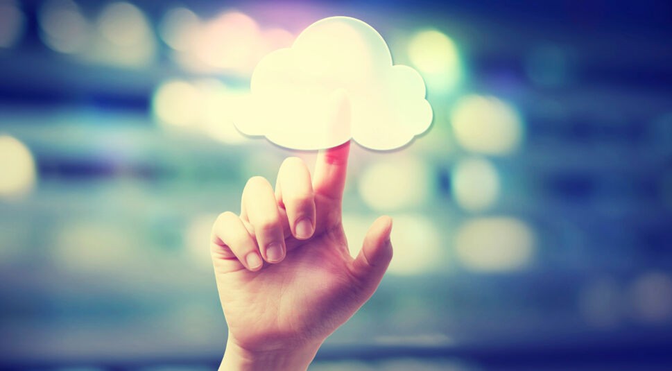 Hand pressing a cloud computing icon