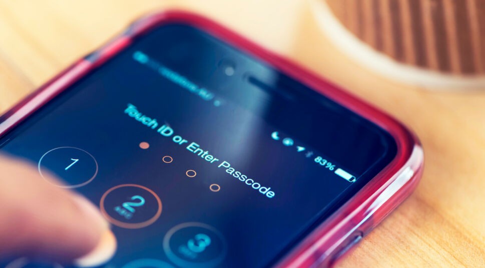 Apple iphone 6 on a table showing passcode.