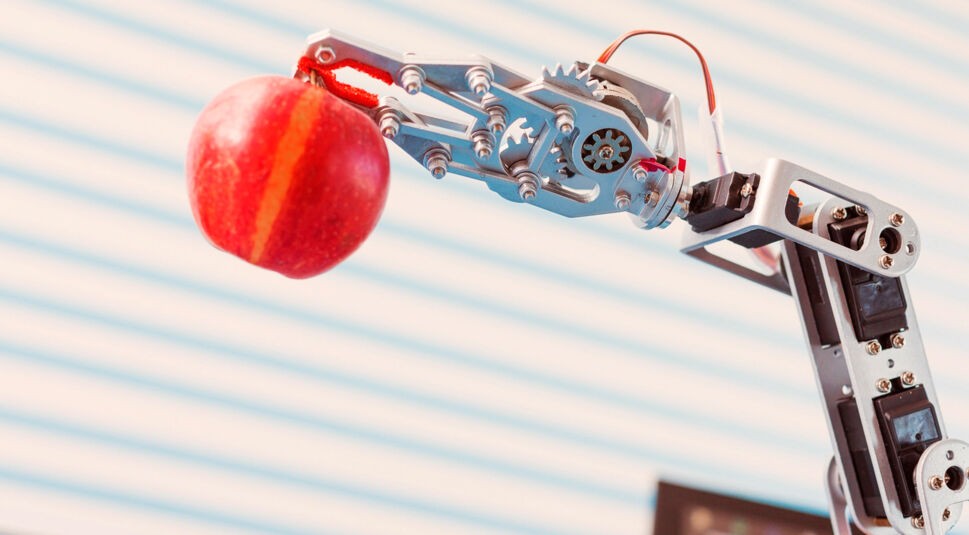 red apple in a robot arm