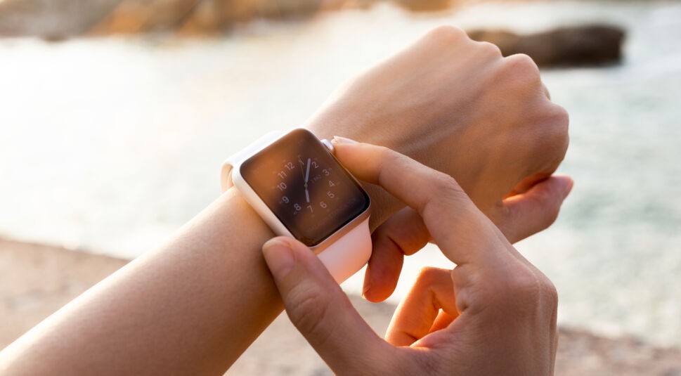 Istanbul, Turkey - August 2, 2015: Istanbul, Turkey - August 2, 2015: A woman wearing 42mm stainless steel Apple Watch with white sports band. The Apple Watch became available April 24, 2015, bringing a new way to receive information at a glance, using apps designed specifically for the wrist.