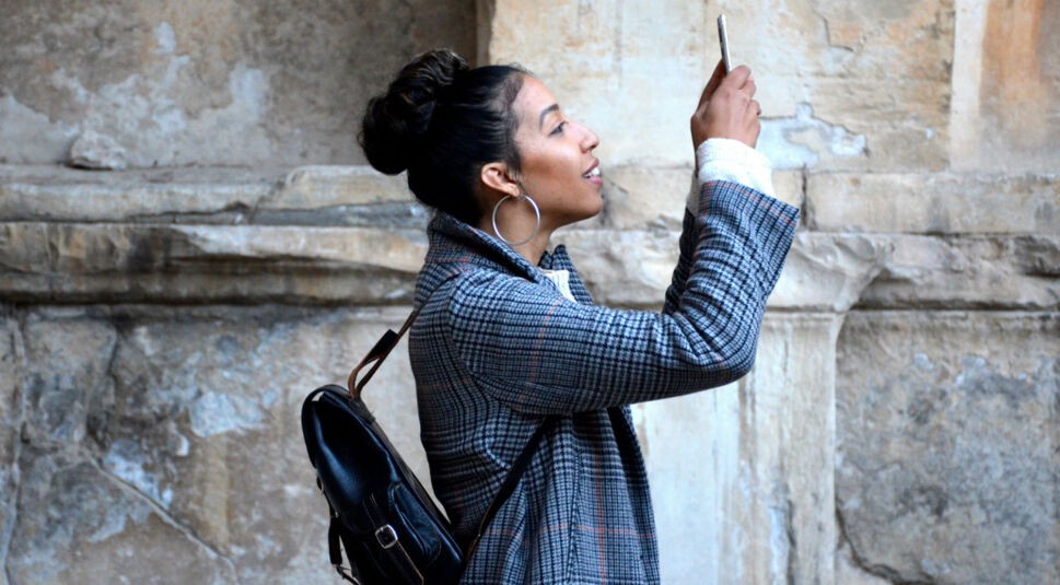 Junge Frau schießt Foto mit dem Smartphone .