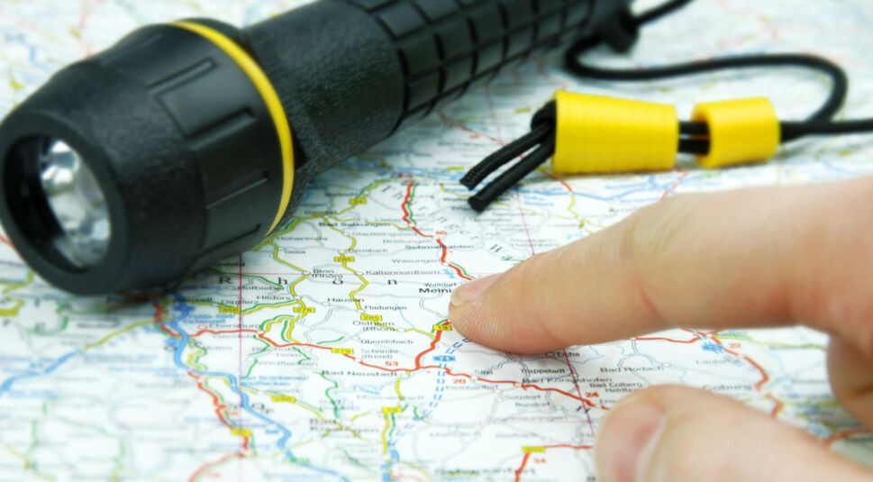 Taschenlampe und Landkarte zu sehen.