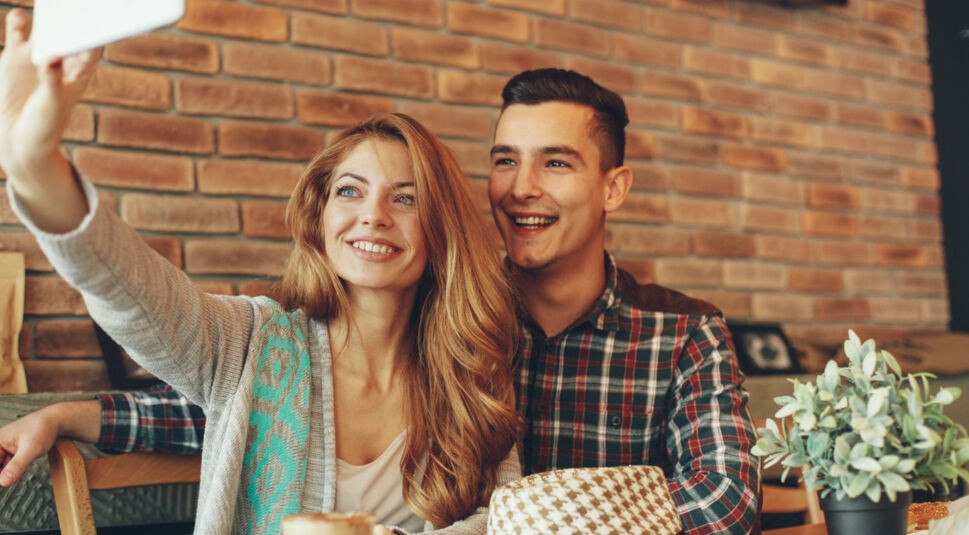 Junges Paar schießt Selfie mit dem Smartphone.
