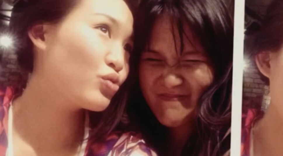 Zwei junge Frauen posieren für einen Schnappschuss und ziehen dabei Grimassen.