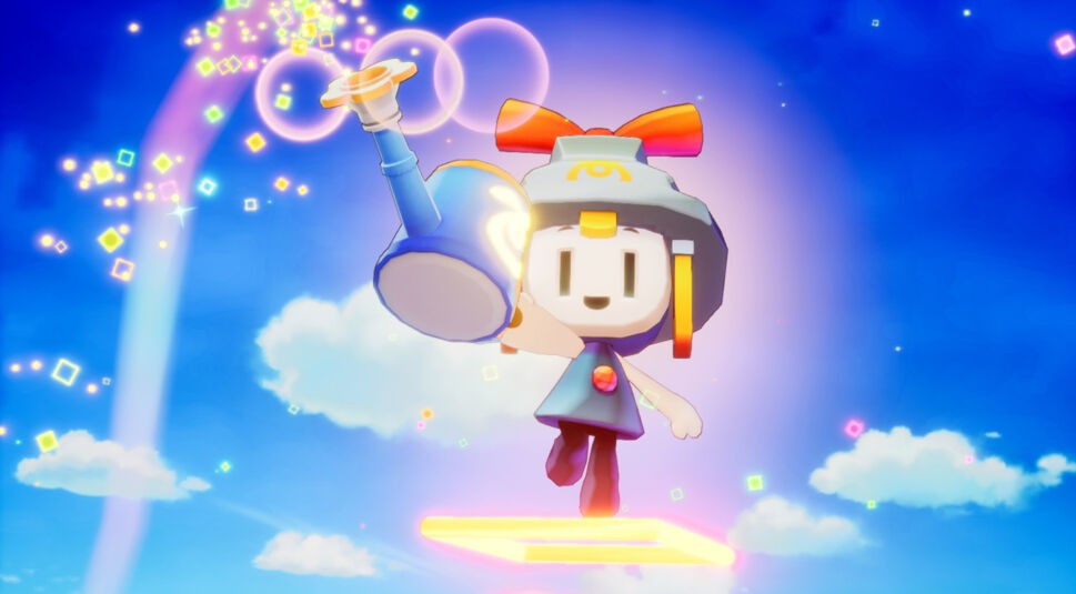 Auf dem Bild aus Mario & Luigi: Brothership Test ist die Figur Connetta vor einem strahlend blauen Himmel zu sehen. Connetta schwebt auf einer leuchtenden Plattform und hält eine blaue Kanone, aus der bunte, schimmernde Quadrate und Lichteffekte herausströmen. Mit einem fröhlichen Ausdruck und einem großen roten Schleifenband auf dem Kopf fügt sich Connetta perfekt in die magische, himmlische Szenerie ein.