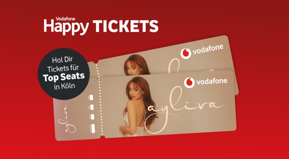 Diese Grafik im Ayliva-Tickets-Artikel zeigt zwei Konzertkarten mit einem Porträt von Sängerin Ayliva und dem Vodafone-Logo. Der Hintergrund ist rot, oben steht „Vodafone Happy TICKETS“. Ein schwarzer Kreis links trägt den Text: „Hol Dir Tickets für Top Seats in Köln“.