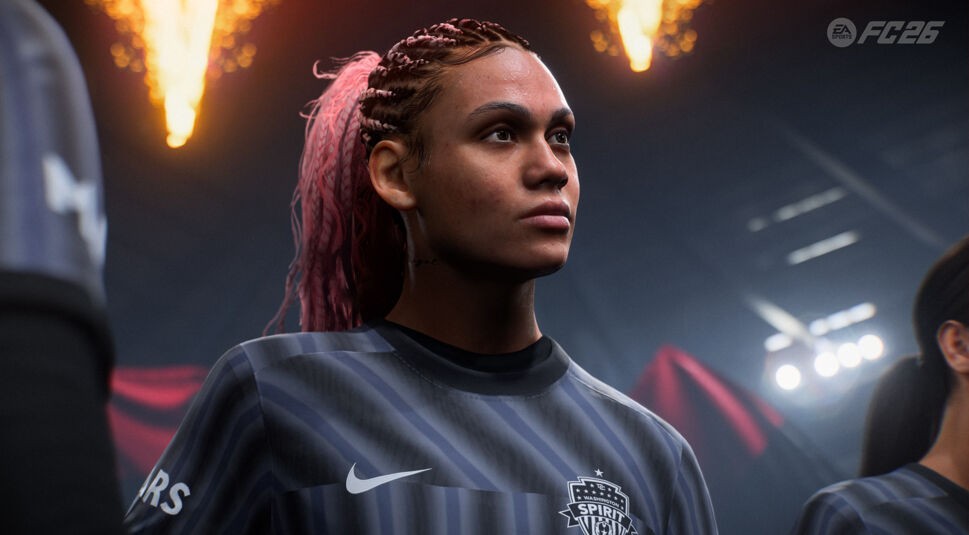 Auf diesem Screenshot aus „EA Sports FC 26“ ist Trinity Rodman im Trikot von Washington Spirit zu sehen. Sie steht fokussiert im Stadion, umgeben von dramatischer Beleuchtung und Feuerfontänen im Hintergrund. Ihre geflochtenen Haare sind mit pinken Akzenten verziert und ihr entschlossener Blick spricht für die emotionale Spannung vor dem Spiel.