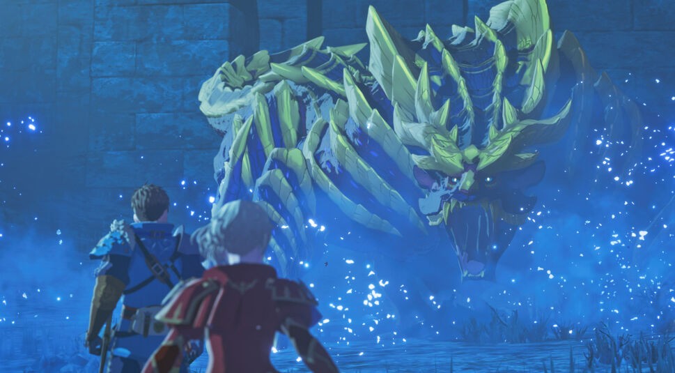 In dieser spannungsgeladenen Szene aus Monster Hunter Stories 3 stehen zwei Charaktere, darunter vermutlich der Thronerbe von Azuria und Prinzessin Eleanor, einem bedrohlich wirkenden Magnamalo gegenüber. Das gewaltige Monster leuchtet giftgrün und lila im blauen Licht einer Höhle, während magische Partikel durch die Luft wirbeln