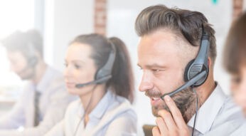 Call center worker accompanied by his team.