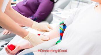 Nurse in drop-in department taking blood from woman donor