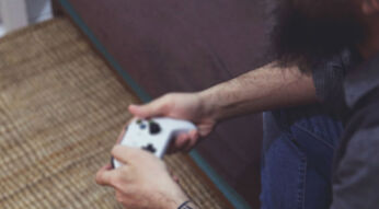 Junger Mann zockt mit seinem Xbox-One-Controller.