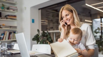 Single mother with baby working in office