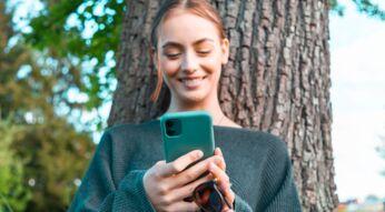 Frau schaut auf ihr Smartphone.