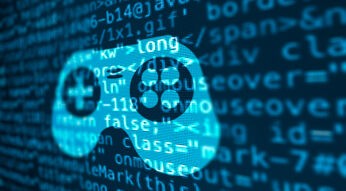 Auf einem Bildschirm ist ein Programmiercode zu sehen, daraus das Symbol eines Konsolen-Controllers eingeblendet.