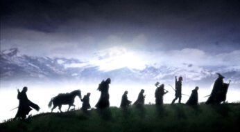 Die neun Gefährten aus "Der Herr der Ringe" gehen einen Berg entlang.