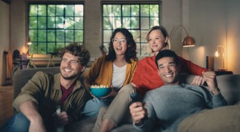 Vier Personen schauen begeistert TV