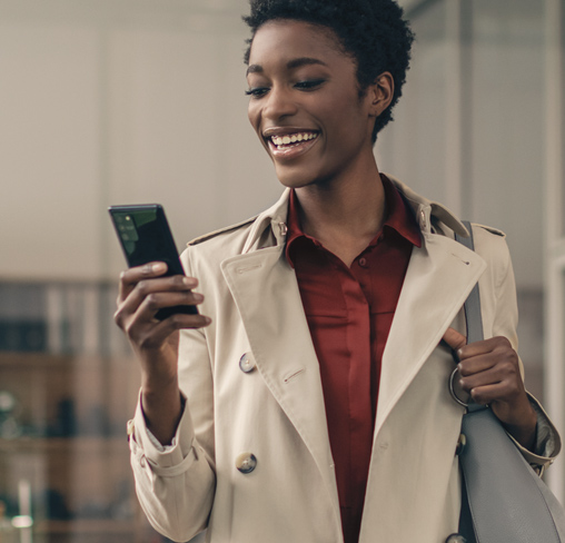 Frau mit Business-Smartphone bucht am Telefon ihre OneNumber oder eSIM